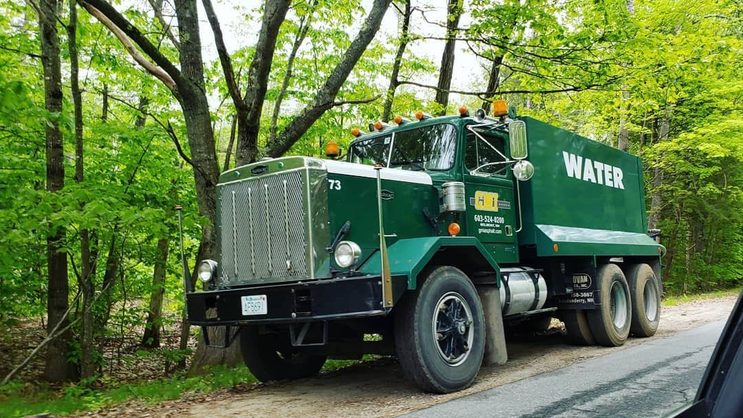 Older GMC tandem axle water truck