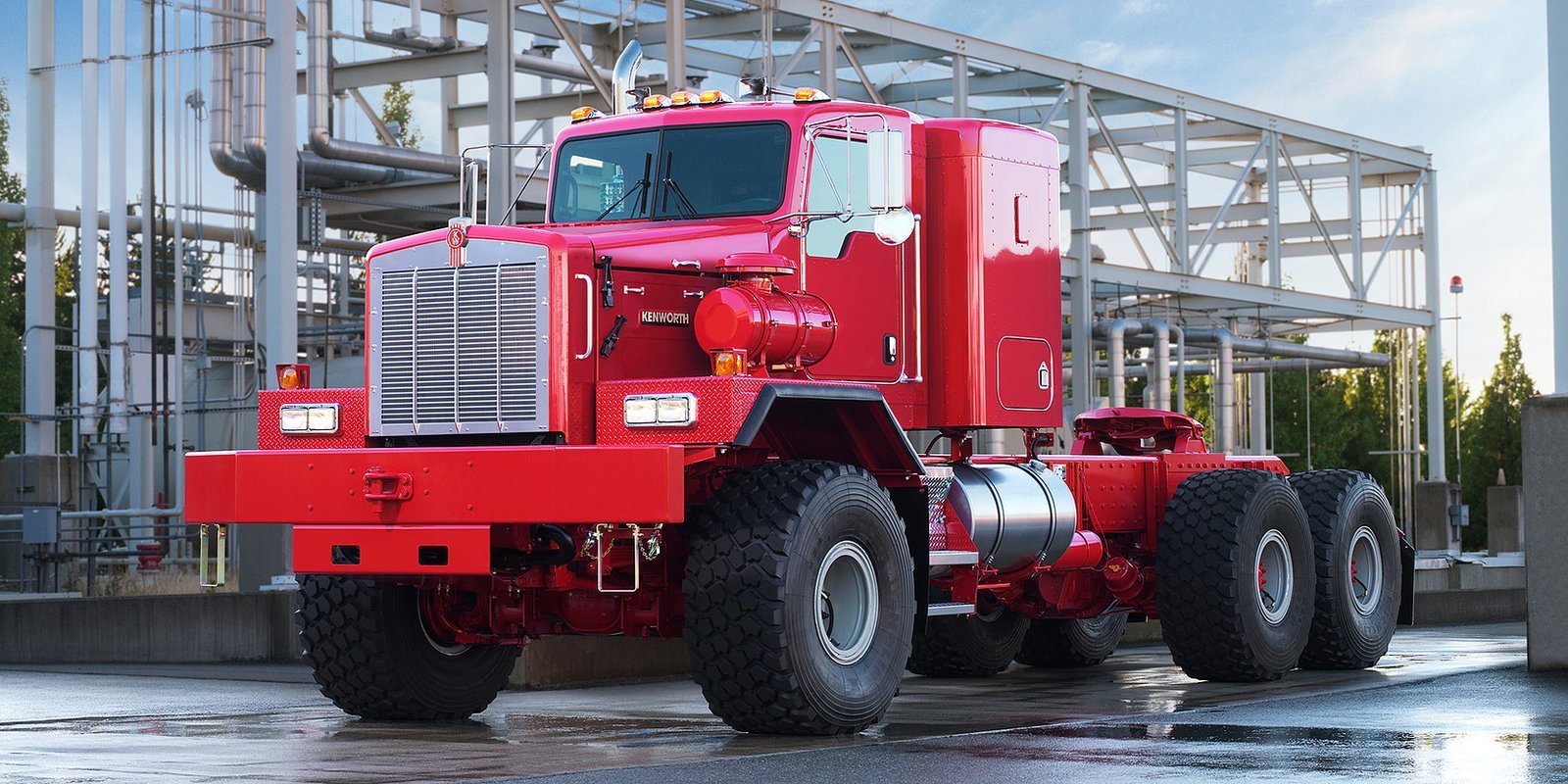 Red Kenworth heavy haul truck at an industrial site