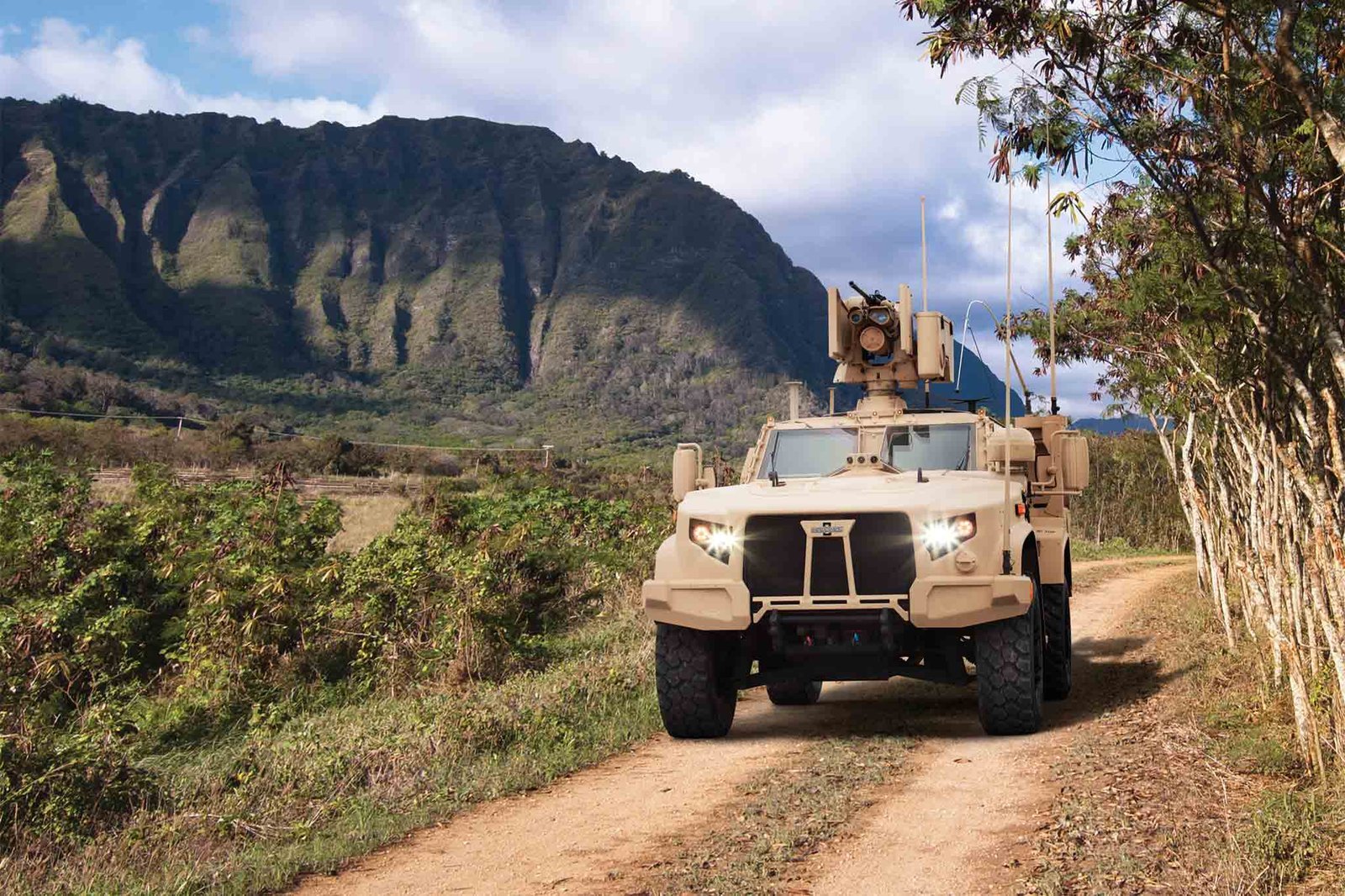 Oshkosh tactical truck on a dirt road